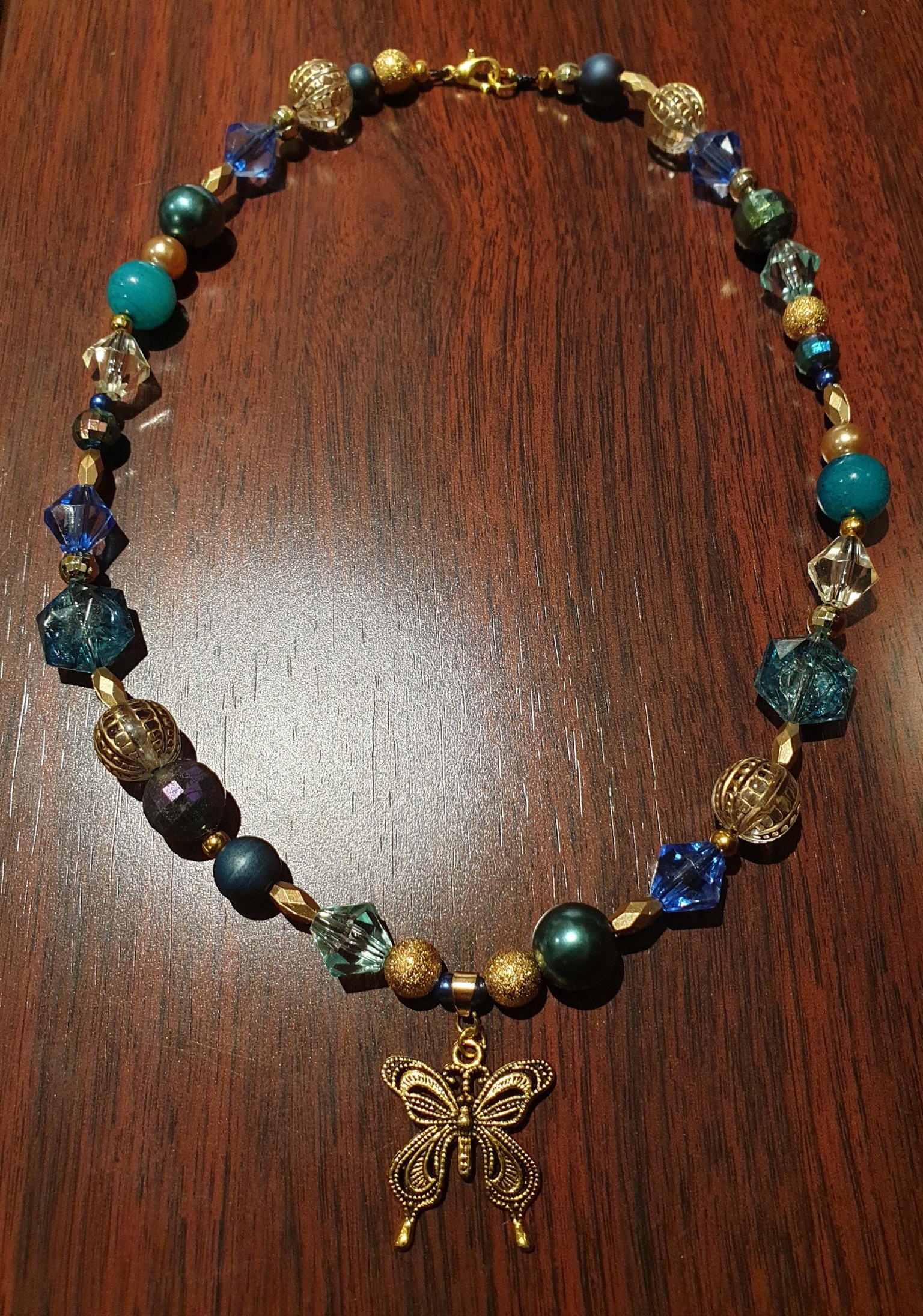 Beaded necklace with butterfly charm - image 1 - student project