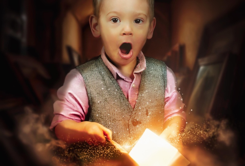 Boy Holding Glowing Book