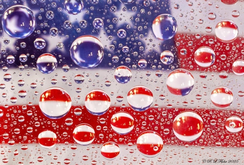 water droplets on 8x10 glass above flag or handkerchief handheld macro