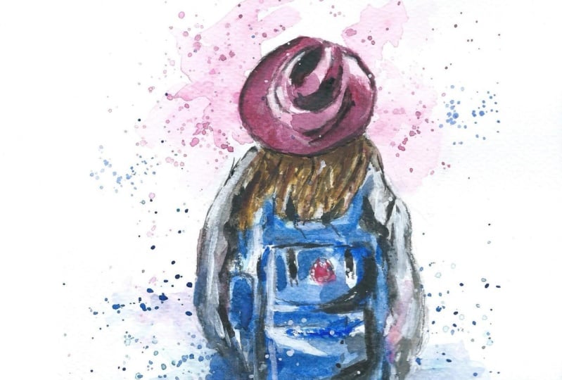 A girl with a backpack and red hat.