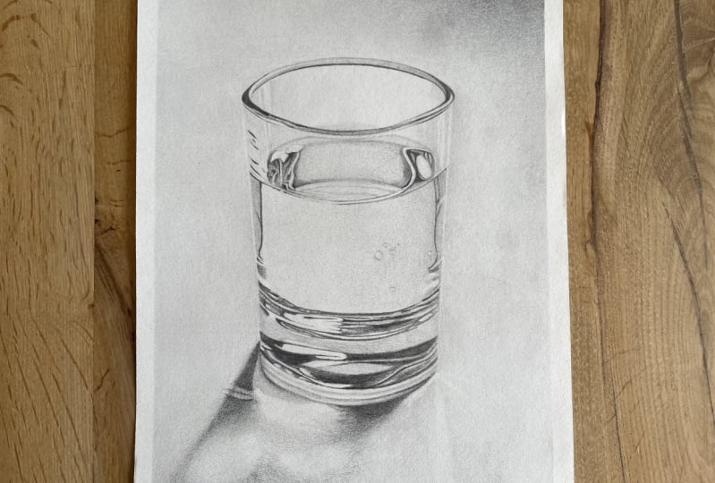 Glass of water with graphite pencils