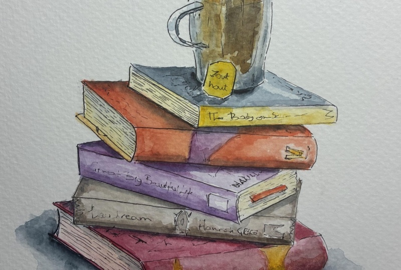 A stack of books with a cup of tea