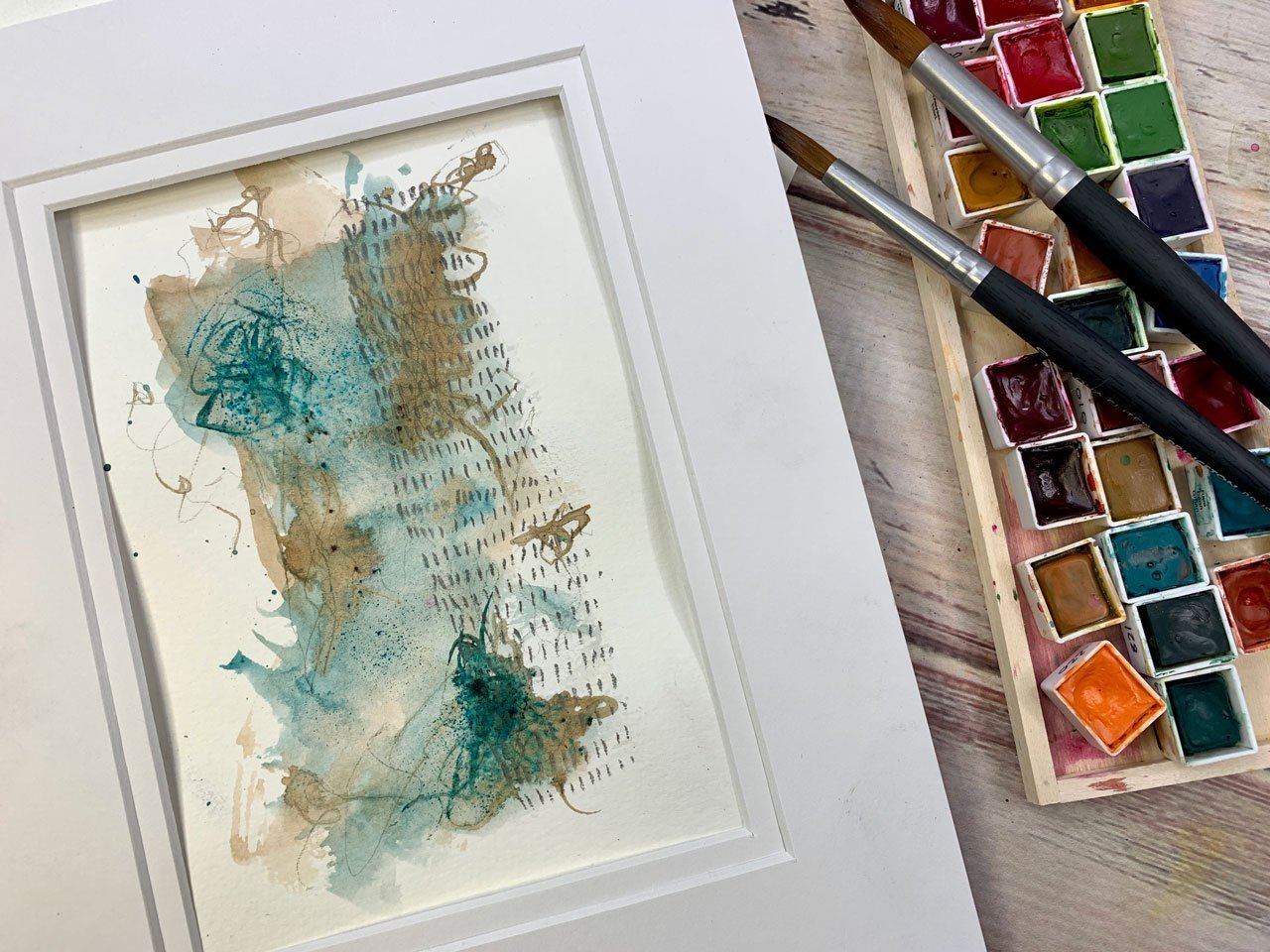 Abstract iridescent watercolor paint in warm and cool tones on